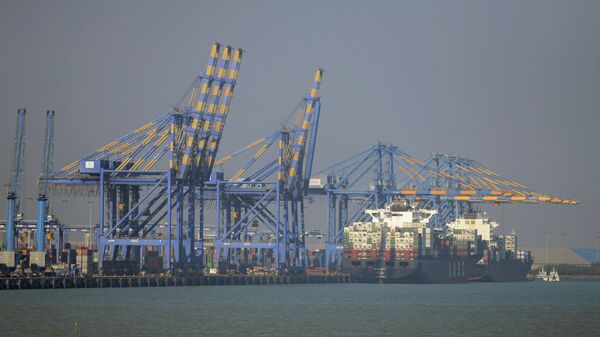 This photo taken on December 21, 2016 shows a container ship (R) docked at India's Adani Port Special Economic Zone (APSEZ) in Mundra - Sputnik International