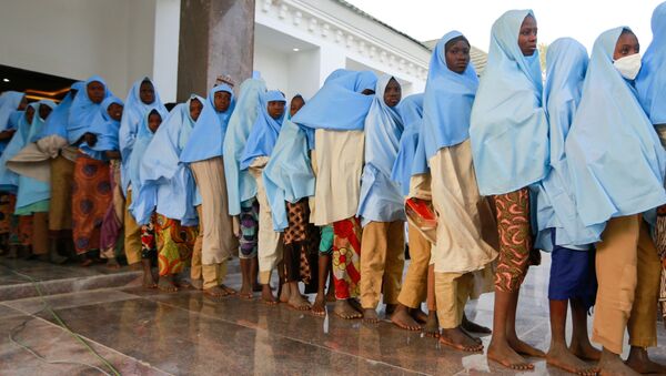 Girls who were kidnapped from a boarding school in the northwest Nigerian state of Zamfara, walk in line after their release in Zamfara, Nigeria March 2, 2021 - Sputnik International