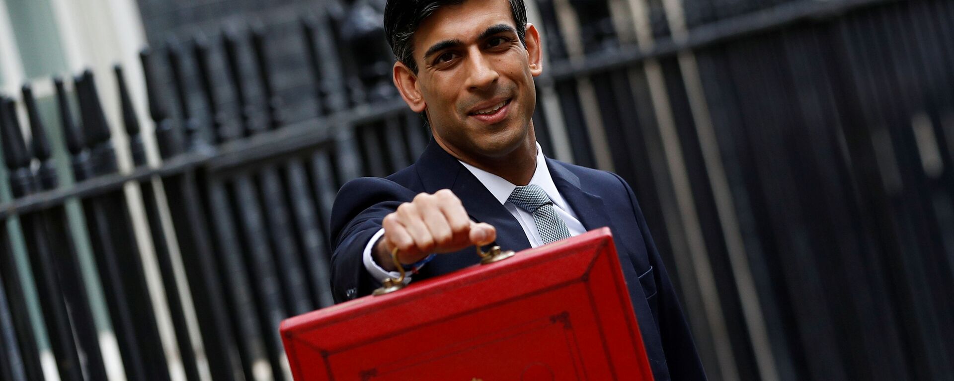 FILE PHOTO: Britain's Chancellor of the Exchequer Rishi Sunak holds the budget box outside his office in Downing Street in London - Sputnik International, 1920, 24.10.2021