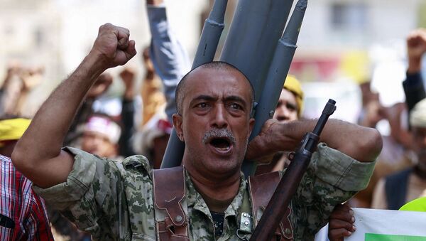 A fighter loyal to Yemen's Huthi rebels carrying a mock missile bearing anti-US slogans on his back chants during a rally commemorating the death of Shiite Imam Zaid bin Ali in the capital Sanaa, on September 14, 2020. - Sputnik International