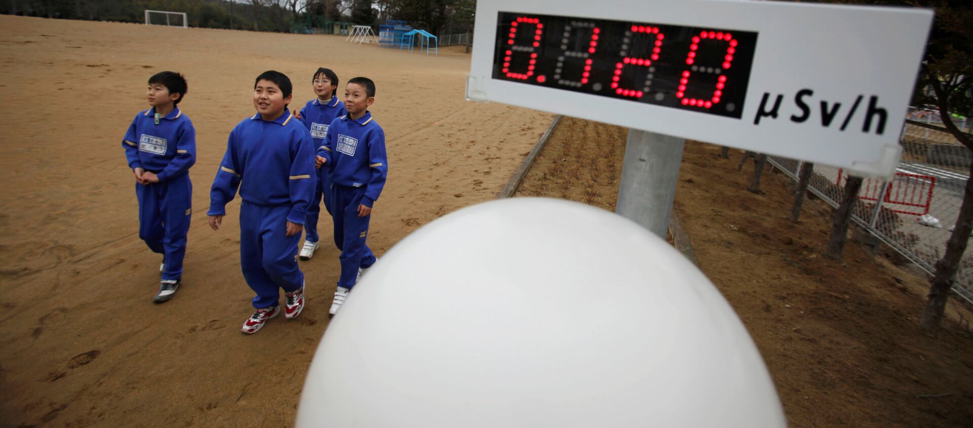 FILE PHOTO: Students walk near a geiger counter, measuring a radiation level of 0.12 microsievert per hour, at Omika Elementary School, located about 21 km (13 miles) from the tsunami-crippled Fukushima Daiichi nuclear power plant, in Minamisoma, Fukushima prefecture, March 8, 2012, ahead of the first anniversary of the March 11 earthquake and tsunami.  - Sputnik International, 1920, 11.03.2021