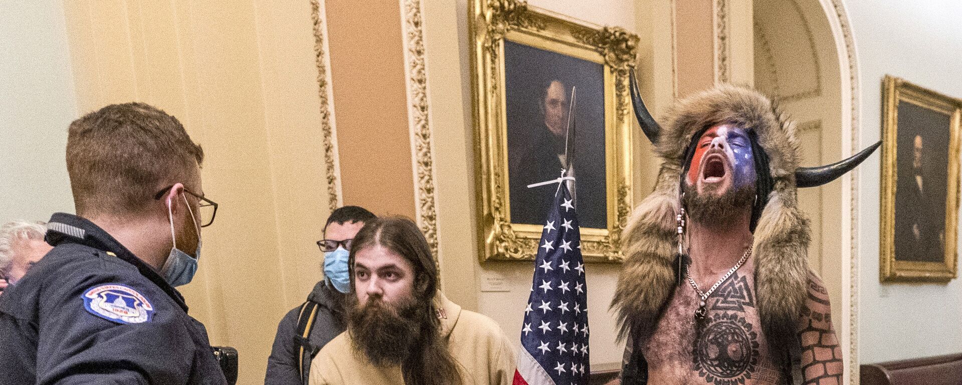 FILE - In this Wednesday, Jan. 6, 2021 file photo, supporters of President Donald Trump, including Jacob Chansley, right with fur hat, are confronted by U.S. Capitol Police officers outside the Senate Chamber inside the Capitol in Washington. Congress is set to hear from former security officials about what went wrong at the U.S. Capitol on Jan. 6. That's when when a violent mob laid siege to the Capitol and interrupted the counting of electoral votes. Three of the four testifying Tuesday resigned under pressure immediately after the attack, including the former head of the Capitol Police.  - Sputnik International, 1920, 02.11.2021