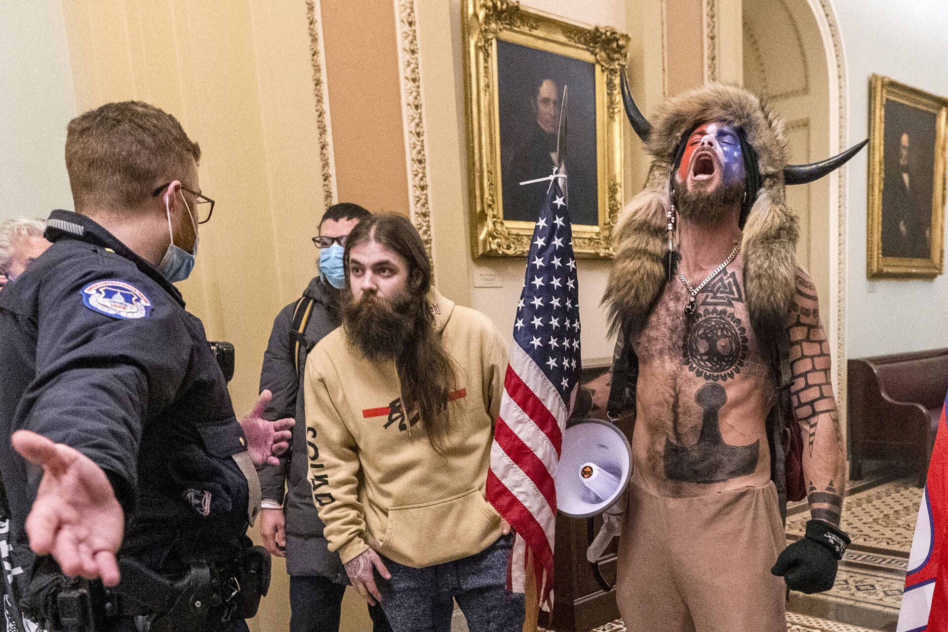 FILE - In this Wednesday, Jan. 6, 2021 file photo, supporters of President Donald Trump, including Jacob Chansley, right with fur hat, are confronted by U.S. Capitol Police officers outside the Senate Chamber inside the Capitol in Washington. Congress is set to hear from former security officials about what went wrong at the U.S. Capitol on Jan. 6. That's when when a violent mob laid siege to the Capitol and interrupted the counting of electoral votes. Three of the four testifying Tuesday resigned under pressure immediately after the attack, including the former head of the Capitol Police.  - Sputnik International, 1920, 07.09.2021
