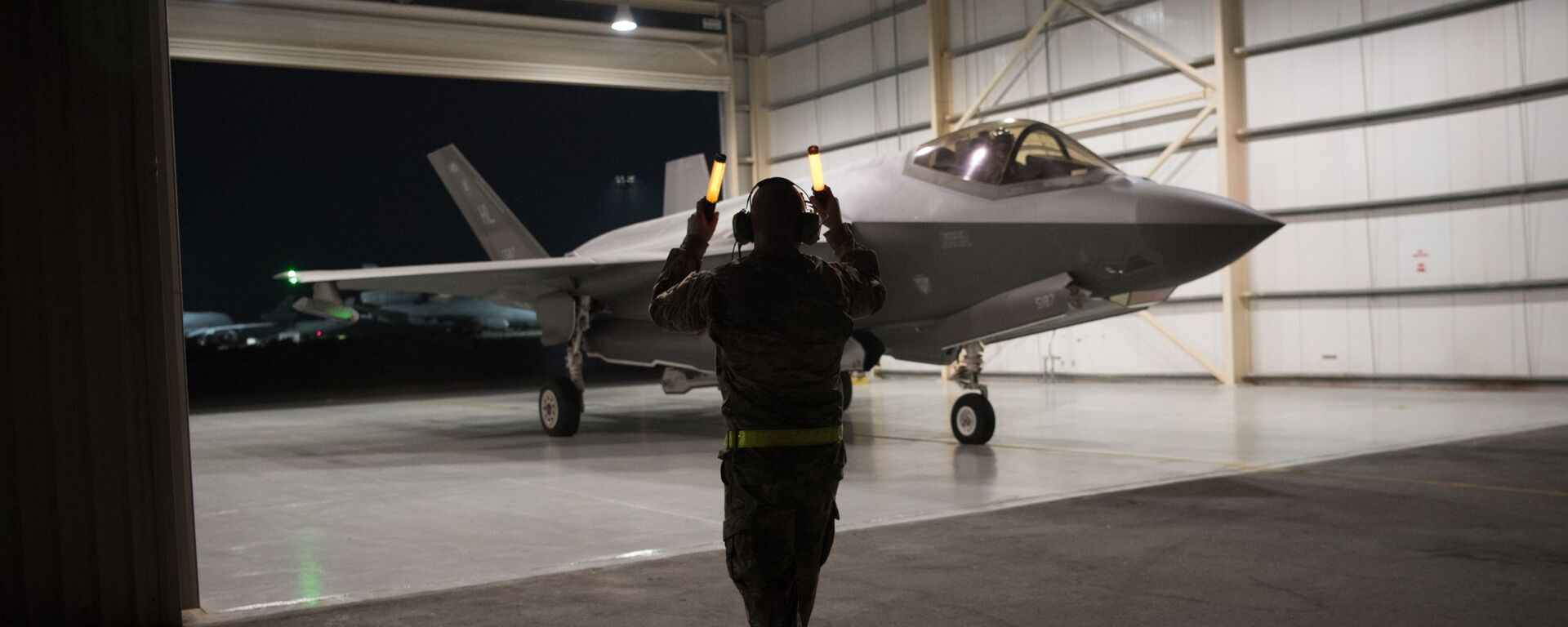 In this Sept. 10, 2019, photo released by the U.S. Air Force, an F-35A Lightning II fighter jet is directed out of a hangar at Al-Dhafra Air Base in the United Arab Emirates. - Sputnik International, 1920, 05.11.2021