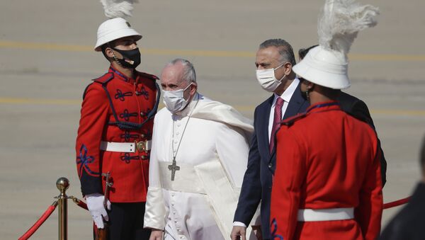 Pope Francis is greeted by Iraqi Prime Minister Mustafa al-Kadhimi upon his arrival at Baghdad's international airport, Iraq, Friday, March 5, 2021. Pope Francis heads to Iraq on Friday to urge the country's dwindling number of Christians to stay put and help rebuild the country after years of war and persecution, brushing aside the coronavirus pandemic and security concerns. - Sputnik International