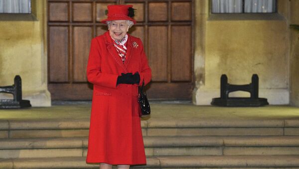 Britain's Queen Elizabeth II, along with other members of the royal family, stands in the quadrangle at Windsor Castle, Windsor, England, Tuesday Dec. 8, 2020, to meet and thank members of the Salvation Army and local volunteers and key workers from organisations and charities in Berkshire. - Sputnik International