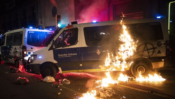 A police van is set on fire as protestors throw molotov cocktails at police during clashes following a protest condemning the arrest of rap singer Pablo Hasél in Barcelona, Spain, Saturday, Feb. 27, 2021. - Sputnik International