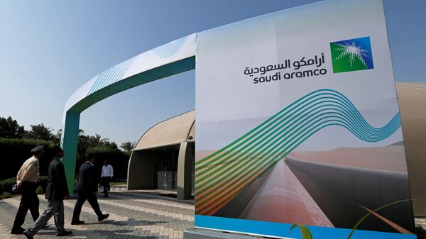 The logo of Aramco is seen as security personnel walk before the start of a press conference by Aramco at the Plaza Conference Center in Dhahran, Saudi Arabia November 3, 2019. - Sputnik International