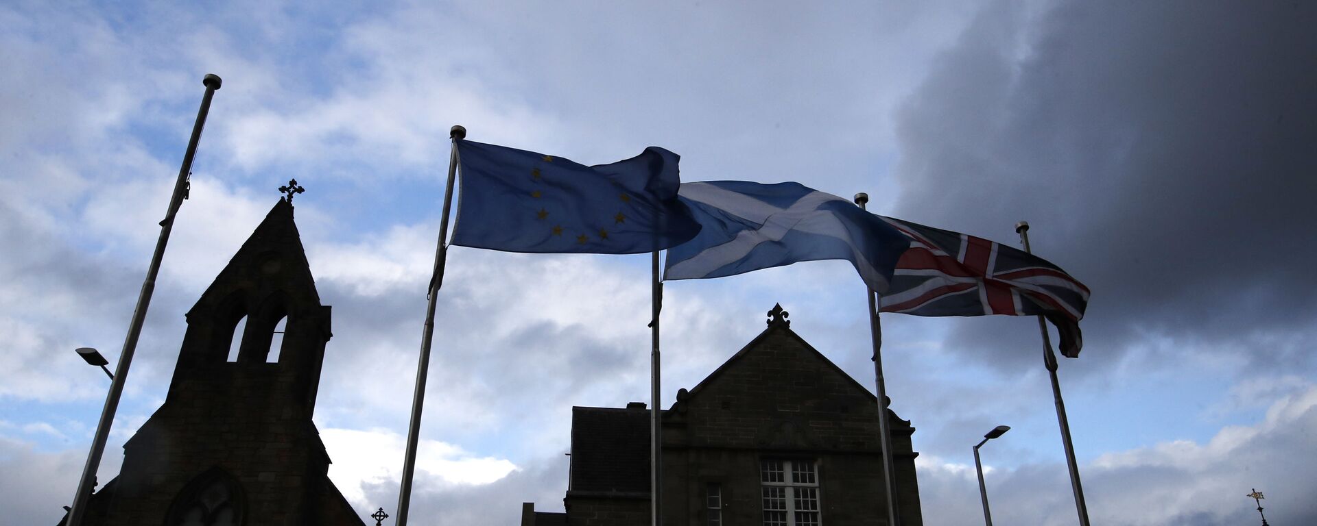 European, Scottish and Great Britain flags float in front of the Scottish Parliament in Edinburgh, Scotland, Wednesday, Sept 4, 2019. The Scottish court says British Prime Minister Boris Johnson's planned suspension of Parliament is lawful. The closely watched decision was revealed Wednesday. It is the first of several challenges to Johnson's maneuver that gives lawmakers little time to prevent Britain from crashing out of the European Union without an agreement on Oct. 31.  - Sputnik International, 1920, 16.01.2023