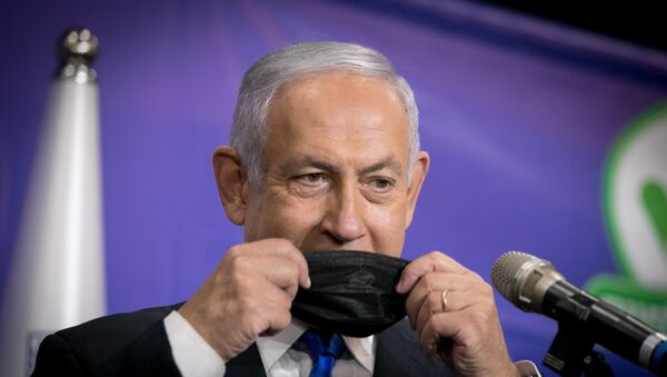 Israeli Prime Minister Benjamin Netanyahu adjusts his mask during a news conference after his meeting with the Israeli citizen no. 5,000,000 to get the Pfizer-BioNTech coronavirus disease (COVID-19) vaccine, in Tel Aviv, Israel, March 8, 2021 - Sputnik International