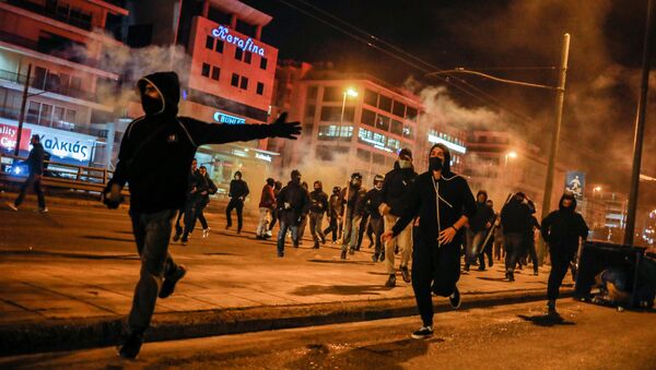 Protesters run during a demonstration against a police crackdown on gatherings, in Athens, Greece, March 9, 2021 - Sputnik International