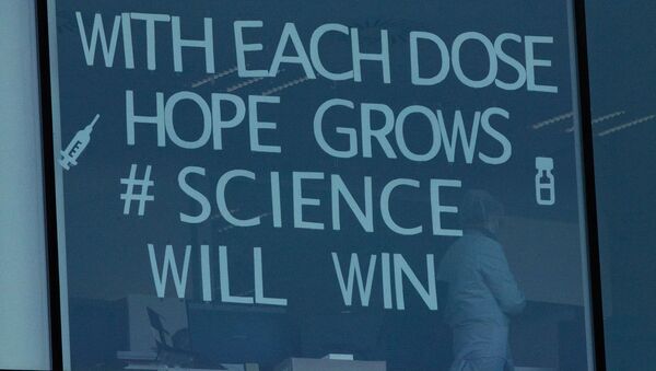 An employee works behind a window with a message taped to it at Pfizer Manufacturing in Puurs, Belgium on Thursday, Feb. 25, 2021. European Union leaders are gathering Thursday to try to inject new energy into the 27-nation bloc's lagging coronavirus vaccination effort as concern mounts that new variants might spread faster than authorities can adapt.  - Sputnik International