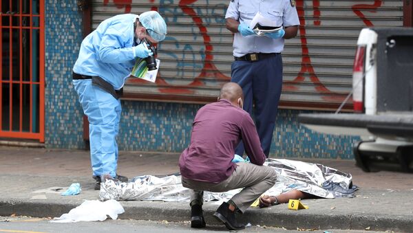 Investigators photograph the body of a victim who was allegedly shot by police during student protests in Braamfontein - Sputnik International