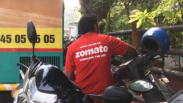 In this photo taken on December 24, 2018, an Indian delivery man working with the food delivery app Zomato sits on his bike in a business district in Mumbai.  - Sputnik International