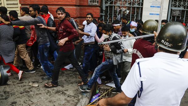 Police chase student activists of the Communist Party of India during a rally against the West Bengal government, as they demand better education and employment opportunities in Kolkata, India, Thursday, Feb. 11, 2021 - Sputnik International
