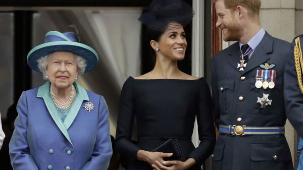 In this Tuesday, 10 July 2018 file photo Britain's Queen Elizabeth II, Meghan the Duchess of Sussex and Prince Harry watch a flypast of Royal Air Force aircraft pass over Buckingham Palace in London. - Sputnik International