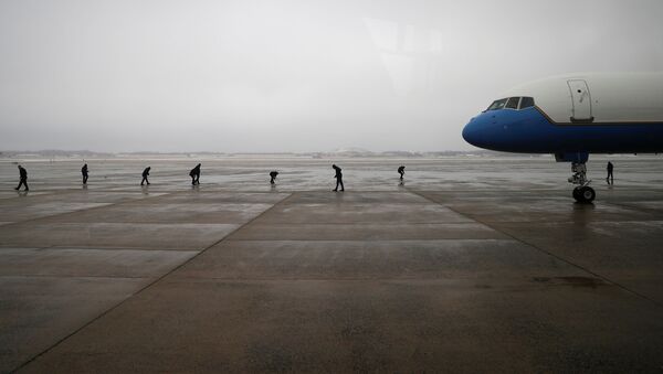 Air Force One crew members scan the tarmac following a previous day ice storm, ahead of U.S. President Joe Biden's trip to Michigan, at Joint Base Andrews in Maryland, U.S., February 19, 2021.  - Sputnik International