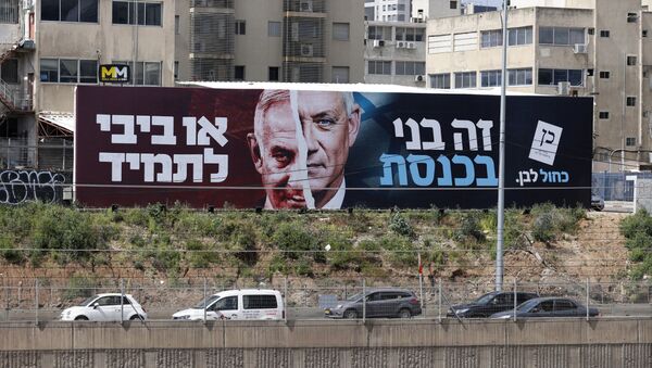 Cars drive past an election campaign billboard for Israel's Blue and White opposition party led by Benny Gantz (R) depicting him and Israeli Prime Minister Benjamin Netanyahu of the Likud party, on a highway in the coastal city of Tel Aviv, on March 12, 2021, ahead of the March 23 general election. The writing in Hebrew reads Benny to the Knesset or Bibi for ever. - Sputnik International