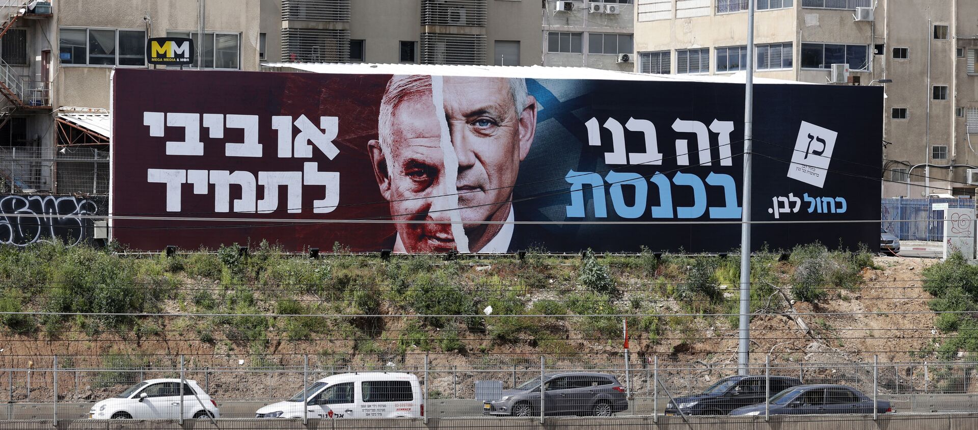 Cars drive past an election campaign billboard for Israel's Blue and White opposition party led by Benny Gantz (R) depicting him and Israeli Prime Minister Benjamin Netanyahu of the Likud party, on a highway in the coastal city of Tel Aviv, on March 12, 2021, ahead of the March 23 general election. The writing in Hebrew reads Benny to the Knesset or Bibi for ever. - Sputnik International, 1920, 25.03.2021