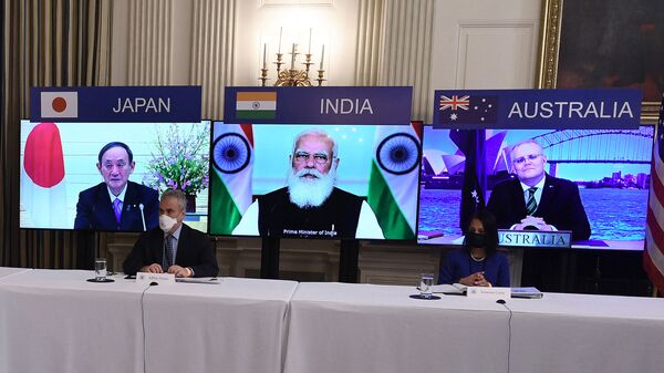 (On screens, L-R) Japanese Prime Minister Yoshihide Suga, Indian Prime Minister Narendra Modi and Australian Prime Minister Scott Morrison listen during a virtual meeting of the Quad alliance members: Australia, India, Japan and the US, in the State Dining Room of the White House in Washington, DC, on March 12, 2021. - Sputnik International