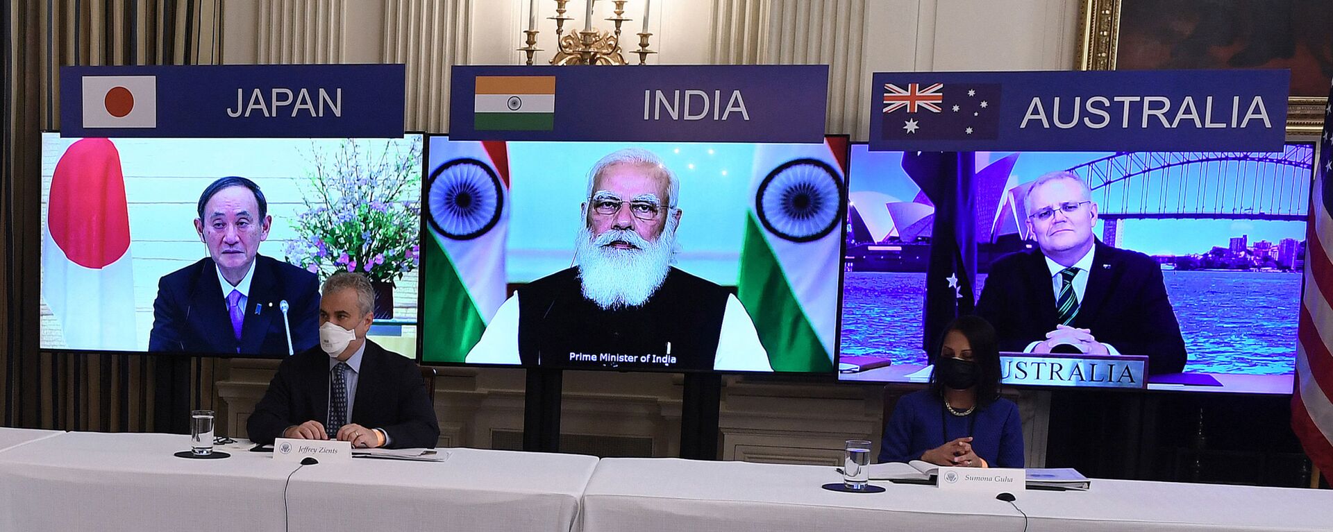 (On screens, L-R) Japanese Prime Minister Yoshihide Suga, Indian Prime Minister Narendra Modi and Australian Prime Minister Scott Morrison listen during a virtual meeting of the Quad alliance members: Australia, India, Japan and the US, in the State Dining Room of the White House in Washington, DC, on March 12, 2021. - Sputnik International, 1920, 22.04.2021