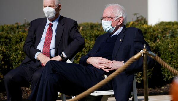 U.S. Senator Bernie Sanders (I-VT) listens with other guests as President Joe Biden speaks about the $1.9 trillion American Rescue Plan Act  during an event to celebrate the legislation in the Rose Garden at the White House in Washington, U.S., March 12, 2021. - Sputnik International