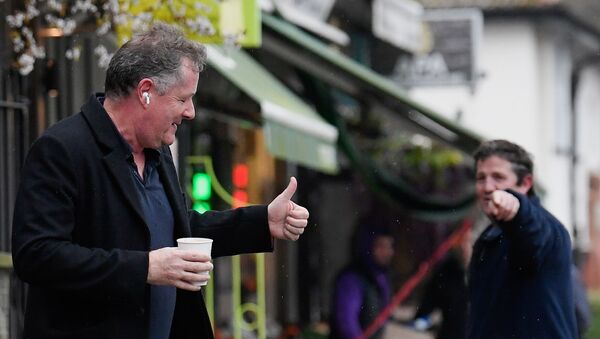 Journalist and television presenter Piers Morgan gestures back to a passerby as he walks near his house, after he left his high-profile breakfast slot with the broadcaster ITV, following his long-running criticism of Prince Harry's wife Meghan, in London, Britain, March 10, 2021 - Sputnik International