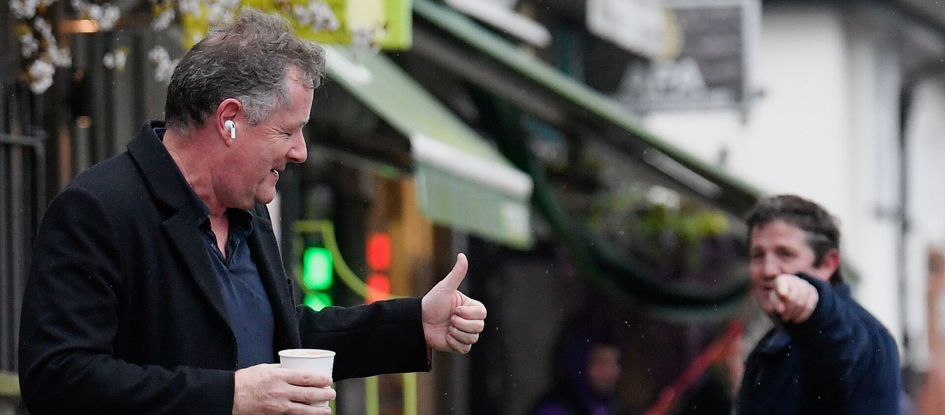 Journalist and television presenter Piers Morgan gestures back to a passerby as he walks near his house, after he left his high-profile breakfast slot with the broadcaster ITV, following his long-running criticism of Prince Harry's wife Meghan, in London, Britain, March 10, 2021 - Sputnik International, 1920, 13.03.2021