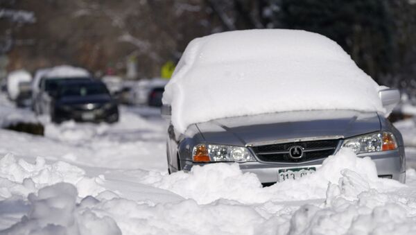 A sedan is buried after more than a foot of snow left by a late winter storm that swept over the region Thursday, Feb. 25, 2021, in Denver.  - Sputnik International