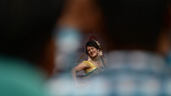A  traditional Lavani folk dancer is seen through a gap among the audience during a performance for sex workers in the red light district of Kamathipura in Mumbai on 28 August 2015, ahead of the Hindu festival 'Raksha Bandhan' - Sputnik International