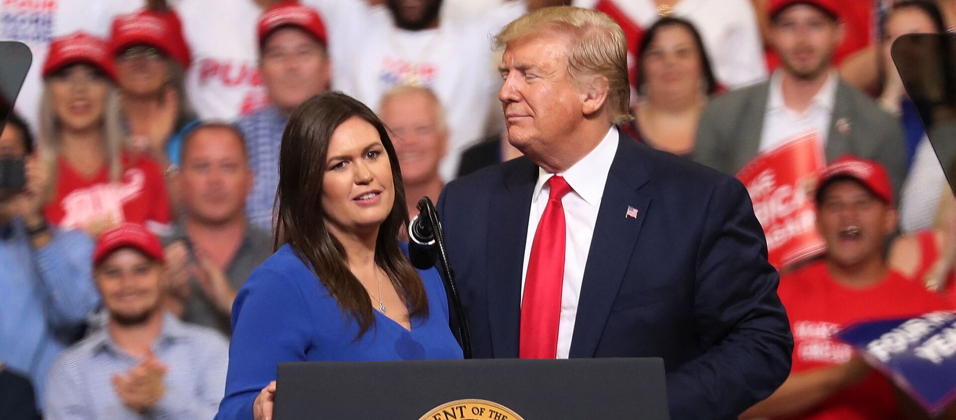  JUNE 18: U.S. President Donald Trump stands with Sarah Huckabee Sanders, who announced that she is stepping down as the White House press secretary, during his rally where he announced his candidacy for a second presidential term at the Amway Center on June 18, 2019 in Orlando, Florida - Sputnik International, 1920, 15.03.2021