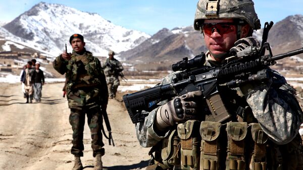 A US Army Soldier patrols with Afghan soldiers to check on conditions in the village of Yawez in Wardak province, Afghanistan, 17 February 2010 - Sputnik International
