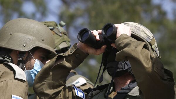 This picture taken on 9 March 2021, near the northern Israeli kibbutz of Misgav Am, shows Israeli forces watching the blue line, a demarcation line drawn by the United Nations to mark Israel's withdrawal from southern Lebanon in 2000.  - Sputnik International