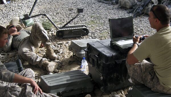 U.S. 101st Airborne Division's 2nd Lt. Corey Wolff, 24, of Chatham, Ohio, right, tests a robot on a resting soldier at Combat Outpost Ashoqeh, Kandahar province, Afghanistan, Sunday, Sept. 12, 2010.  - Sputnik International