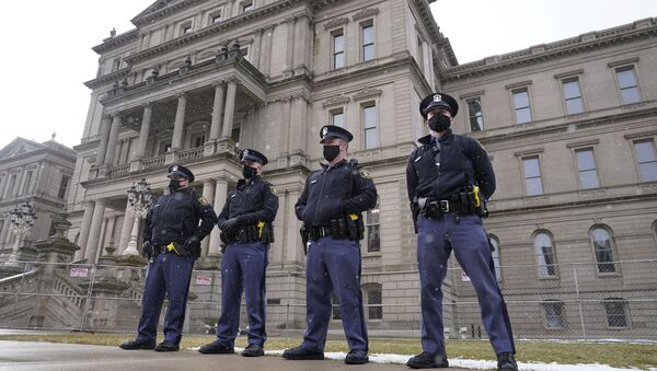 Michigan State Police troopers stand guard outside the state capitol in Lansing, Mich., Sunday, Jan. 17, 2021. - Sputnik International