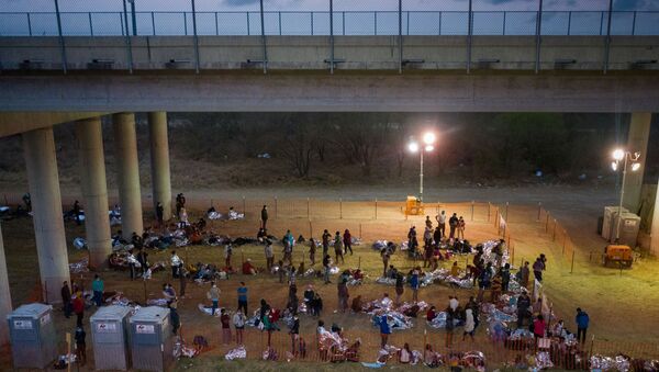 Asylum seeking migrant families and unaccompanied minors from Central America take refuge in a makeshift U.S. Customs and Border Protection processing center under the Anzalduas International Bridge after crossing the Rio Grande river into the United States from Mexico in Granjeno, Texas, U.S., March 12, 2021. REUTERS/Adrees Latif/File Photo - Sputnik International