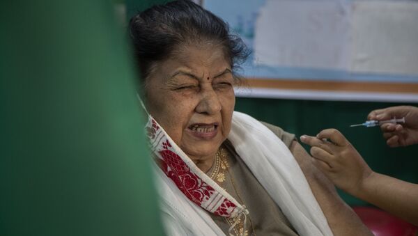 An elderly woman receives the COVID-19 vaccine at a private hospital in Gauhati, India, Thursday, March 4, 2021 - Sputnik International
