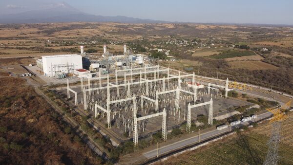In this Feb. 22, 2020 file photo, a newly built power generation plant that is part of a mega-energy project including a natural gas pipeline traversing three states is seen with the Popocatepetl Volcano in the background near Huexca, Morelos state, Mexico. - Sputnik International