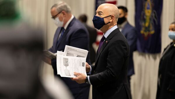 U.S. Homeland Security Secretary Alejandro Mayorkas hands informational pamphlets to essential and public-facing workers arriving to receive their coronavirus disease (COVID-19) vaccine at one of FEMA's Community Vaccination Center in Philadelphia, Pennsylvania, U.S., March 2, 2021. - Sputnik International