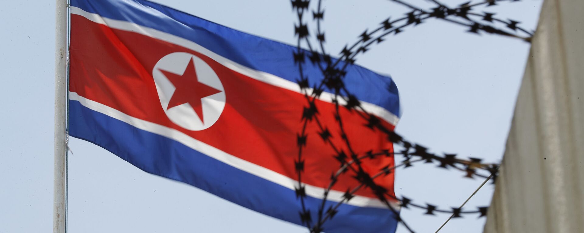North Korean flag flutters behind razor wire on top of a wall at North Korean Embassy in Kuala Lumpur, Malaysia, Monday, March 13, 2017. - Sputnik International, 1920, 12.07.2023