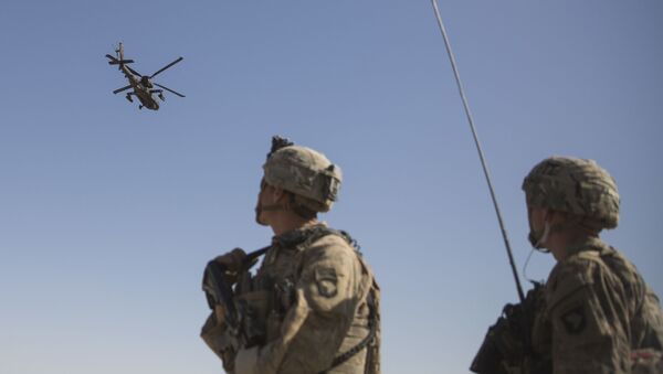 This June 10, 2017 photo released by the U.S. Marine Corps shows an AH-64 Apache attack helicopter provides security from above while CH-47 Chinooks drop off supplies to U.S. Soldiers with Task Force Iron at Bost Airfield, Afghanistan. Sixteen years into its longest war, the United States is sending another 4,000 troops to Afghanistan in an attempt to turn around a conflict characterized by some of the worst violence since the Taliban were ousted in 2001. - Sputnik International