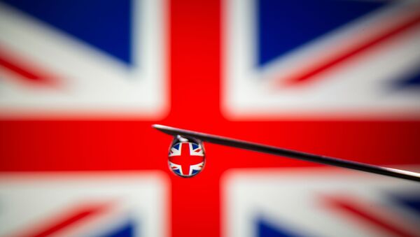 UK flag is reflected in a drop on a syringe needle in this illustration photo taken March 16, 2021. Picture taken March 16, 2021.  - Sputnik International
