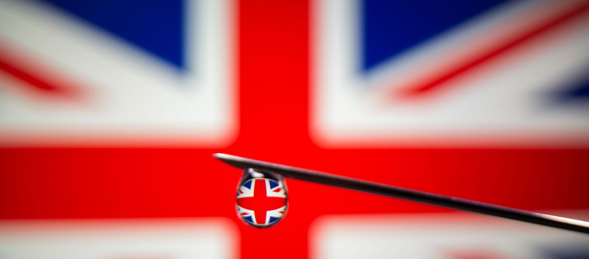 UK flag is reflected in a drop on a syringe needle in this illustration photo taken March 16, 2021. Picture taken March 16, 2021.  - Sputnik International, 1920, 19.03.2021