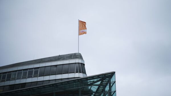 A flag of Germany's Christian Democratic Union party, CDU, the party of Chancellor Angela Merkel, waves in the wind on top of the party's headquarters in Berlin, Germany, March 14, 2021. - Sputnik International