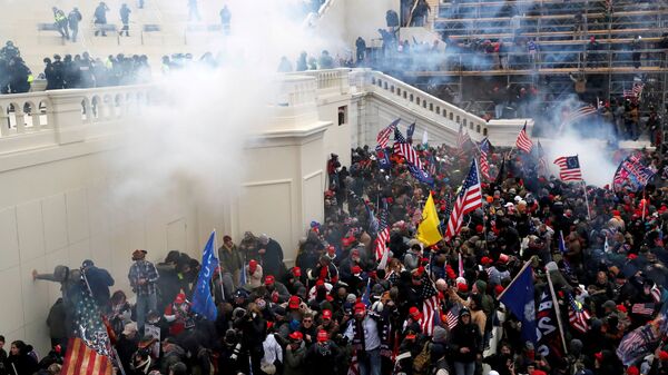 Police release tear gas into a crowd of pro-Trump protesters during clashes at a rally to contest the certification of the 2020 U.S. presidential election results by the U.S. Congress, at the U.S. Capitol Building in Washington, U.S, January 6, 2021. - Sputnik International