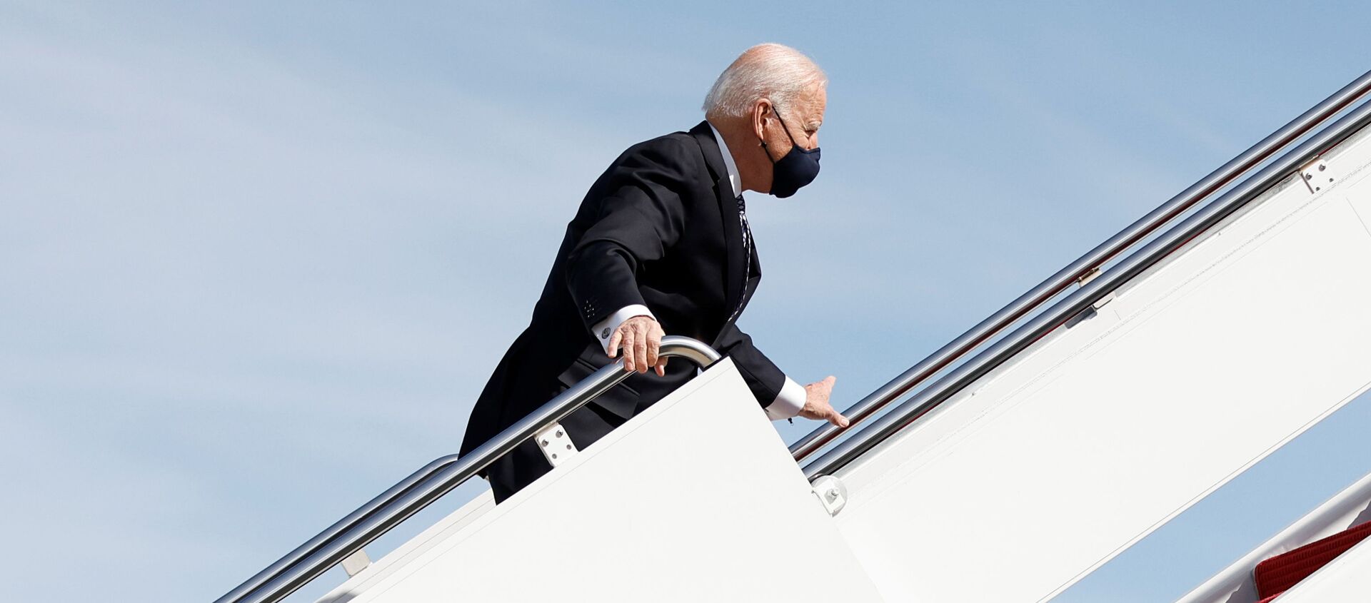 U.S. President Joe Biden grabs onto the railing after he stumbled while boarding Air Force One as he departs Washington on travel to Atlanta, Georgia to promote the $1.9 trillion coronavirus disease (COVID-19) aid package known as the American Rescue Plan, at Joint Base Andrews, Maryland, U.S., March 19, 2021. - Sputnik International, 1920, 19.03.2021