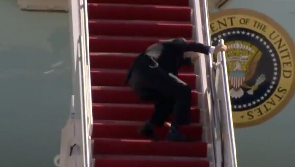 Screenshot captures the moment that US President Joe Biden caught himself after stumbling three times while ascending the airstairs to board Air Force Once. - Sputnik International