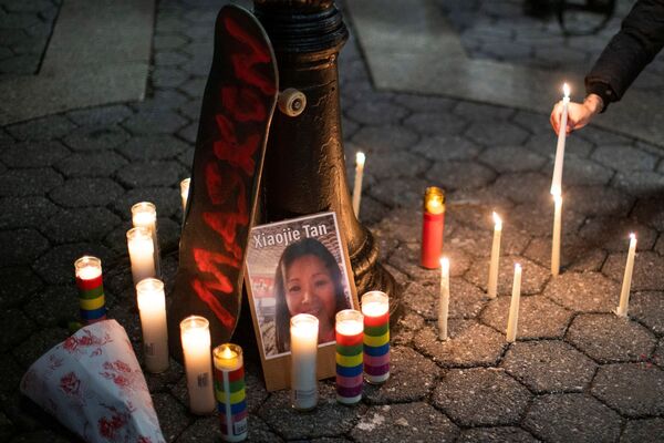 A person lights a candle during a peace vigil to mourn the victims of anti-Asian hate crimes in New York City, New York, U.S., on 19 March 2021. - Sputnik International