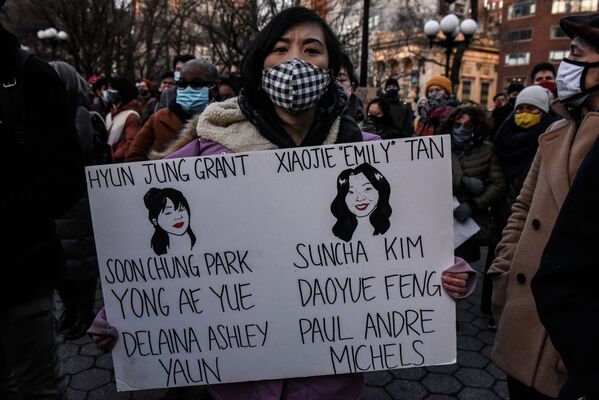 A person holds a sign with the names of the people who died at a peace vigil to honour victims of attacks on Asians on 19 March 2021 in Union Square Park in New York City. - Sputnik International