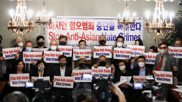 Members of the Atlanta Korean American Committee against Asian Hate Crime pose with placards during a group photo as they meet at Ching Dam, a Korean restaurant, after the fatal shooting at three Georgia spas, in Duluth, Georgia, U.S., 18 March 2021.  - Sputnik International
